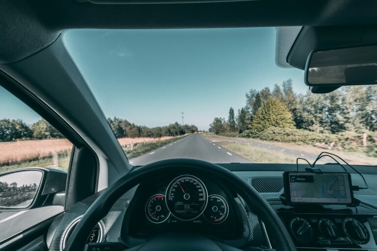 A driver's view through the windshield, where Google Maps on Android Auto now flags traffic lights and stop signs at the next turn
