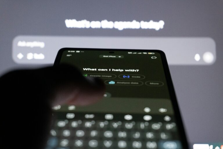 Person typing on a smartphone with an AI chatbot on screen, representing Google's AI Plus subscription and its new Colab perks