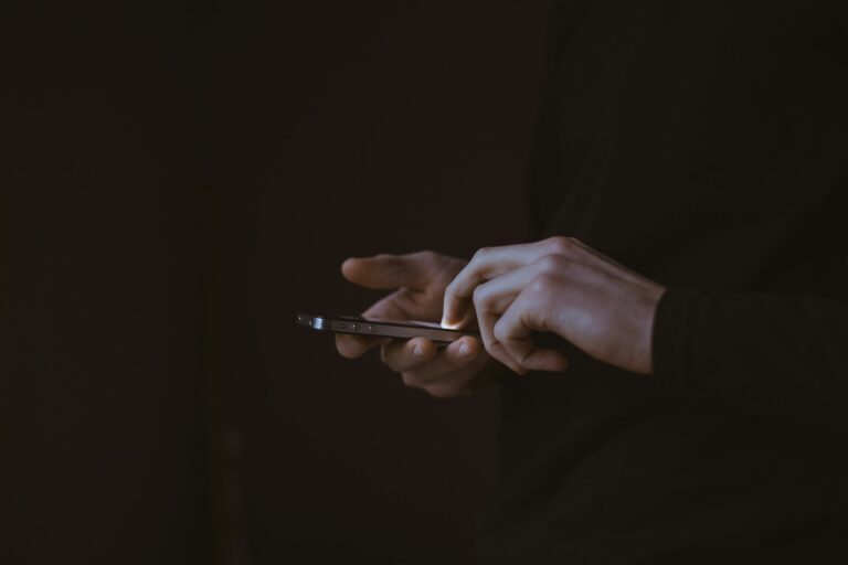Man holding a smartphone to his ear on a call, illustrating Gemini's Call for Me feature placing calls on a user's behalf