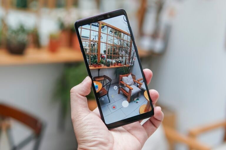 Person holding a black Android smartphone, as a Google Photos bug stops some Pixel and Galaxy owners from editing or deleting pictures