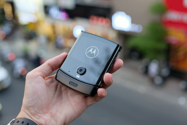 A person holding a smartphone, illustrating Motorola's 2026 Razr foldables now sold at Verizon