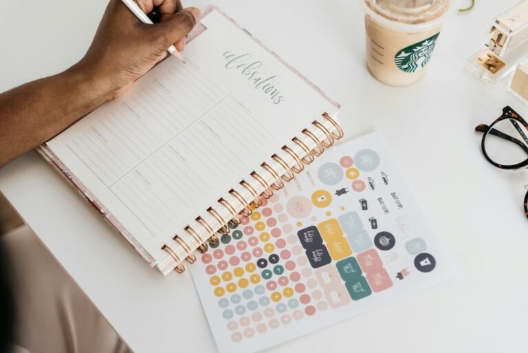 A person writing in a planner at a desk, illustrating scheduling meetings across three time zones in Google Calendar