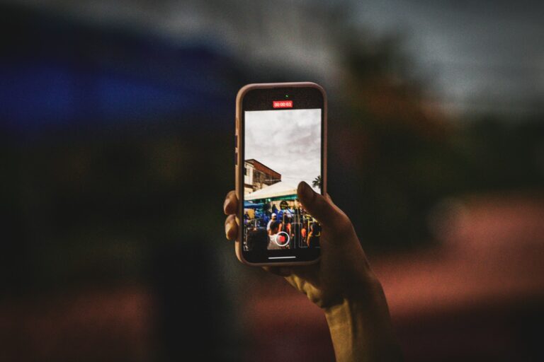 Person taking a photo with a smartphone, illustrating the new Redact and Moods editing tools in Google Photos for Android