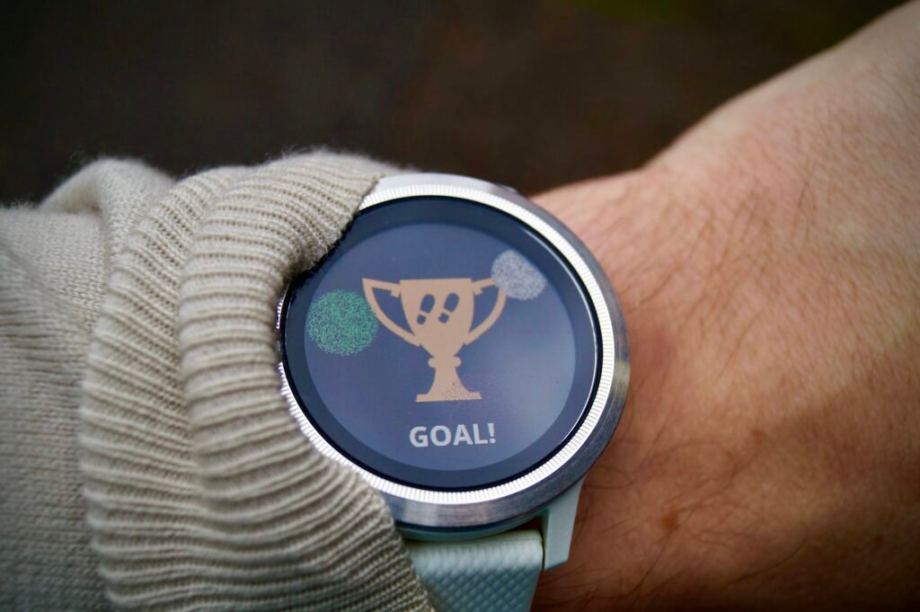 A fitness tracker on a wrist showing an activity goal reached, ahead of Google's Fitbit Edge launch