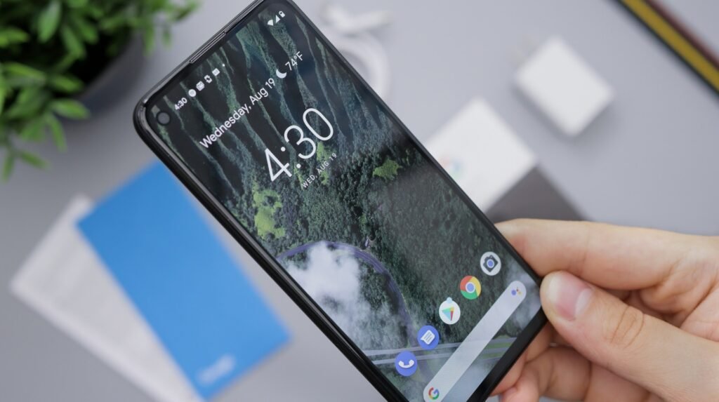 A person holding a black Android smartphone, illustrating how to free up storage space on Android