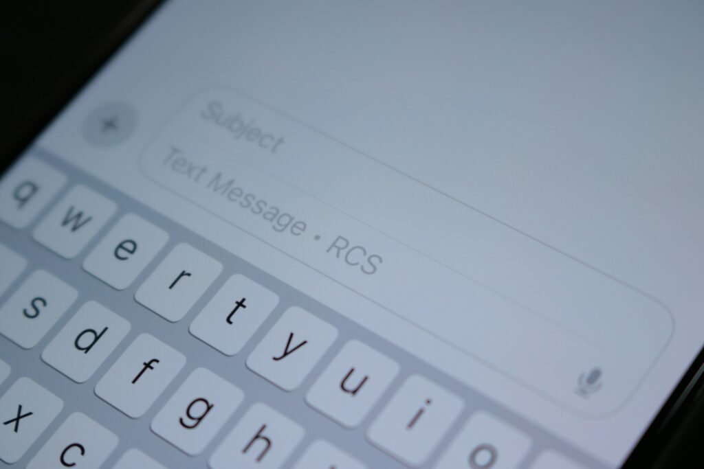 Close-up of a smartphone keyboard while typing a text message, illustrating Android's new scam protections in Google Messages