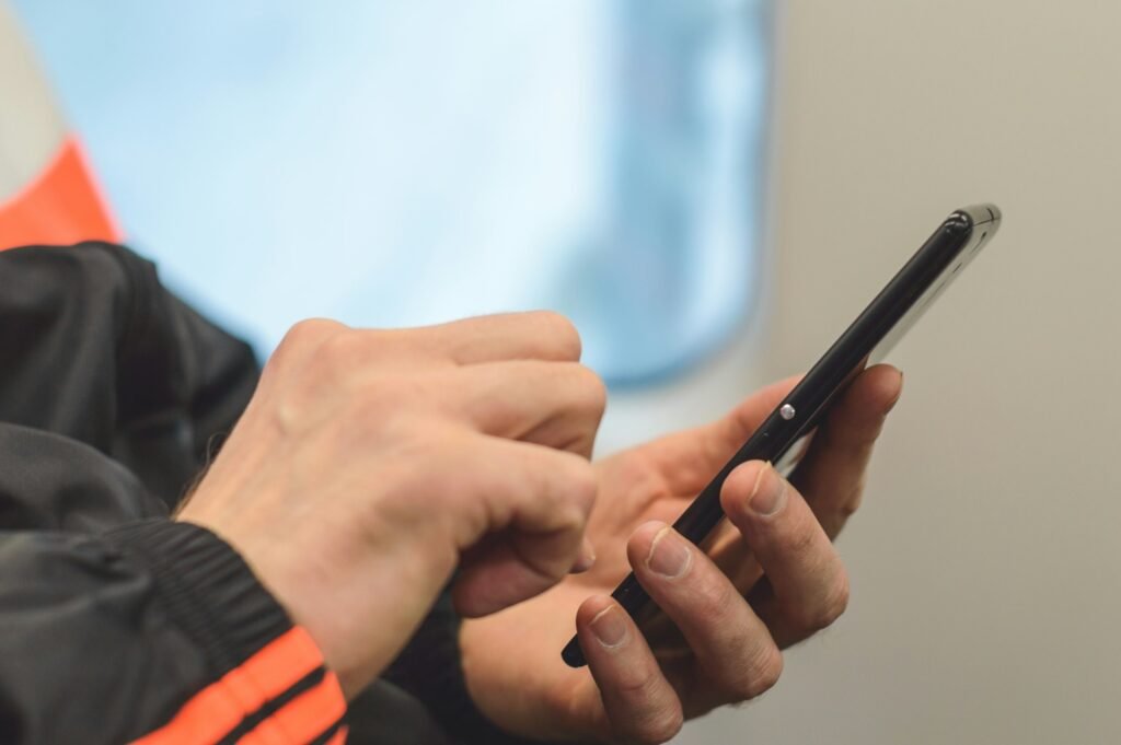 Man checking his smartphone for a verification code, illustrating Gmail's new Copy code button