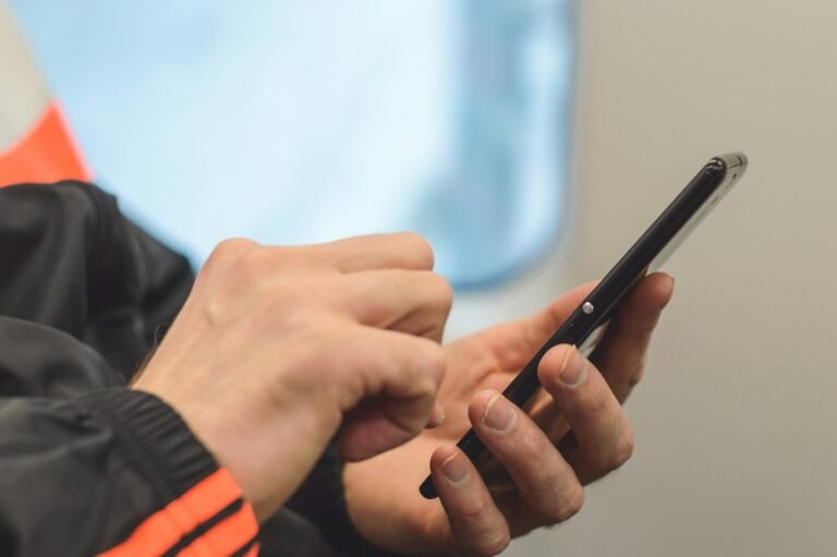 Man checking his smartphone for a verification code, illustrating Gmail's new Copy code button