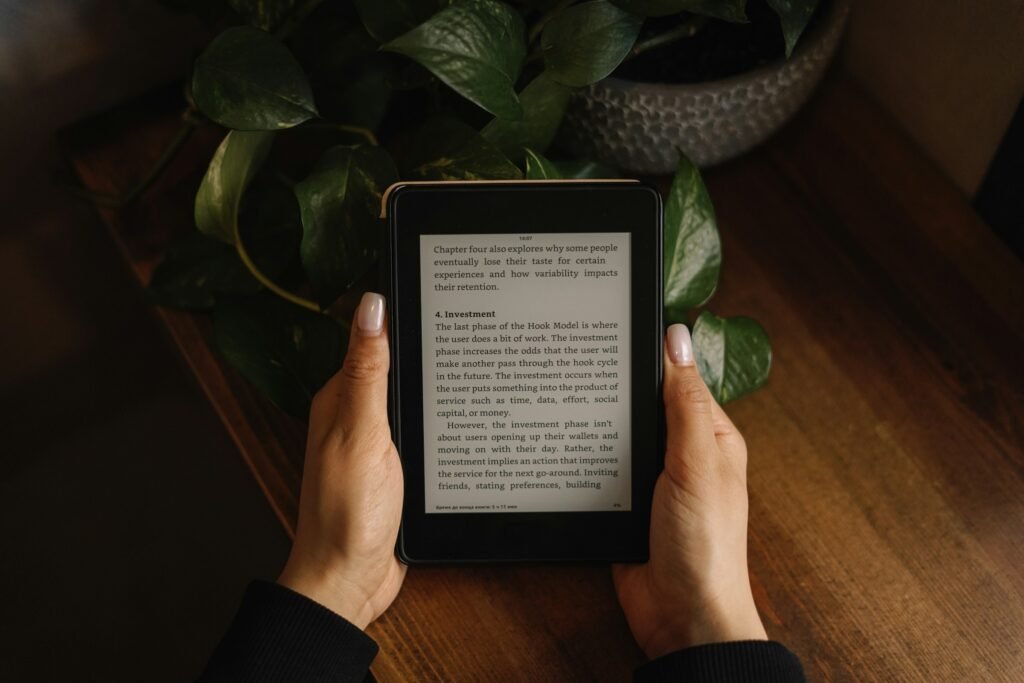 A person holding an E Ink reading device, illustrating the Bigme HiBreak Dual 3's E Ink display