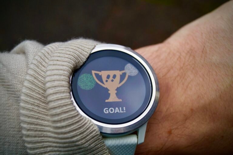 A slim fitness tracker on a wrist showing an activity goal, the kind of band Google's new Fitbit Edge replaces the Charge 6 with