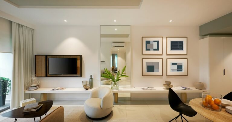 Modern living room with a wall-mounted TV beside framed abstract art, the look TCL's Designer Series Google TVs aim for