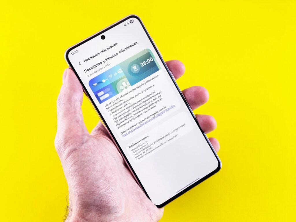 A hand holding an Android phone showing a software update screen, as OnePlus phones move from OxygenOS to ColorOS 17