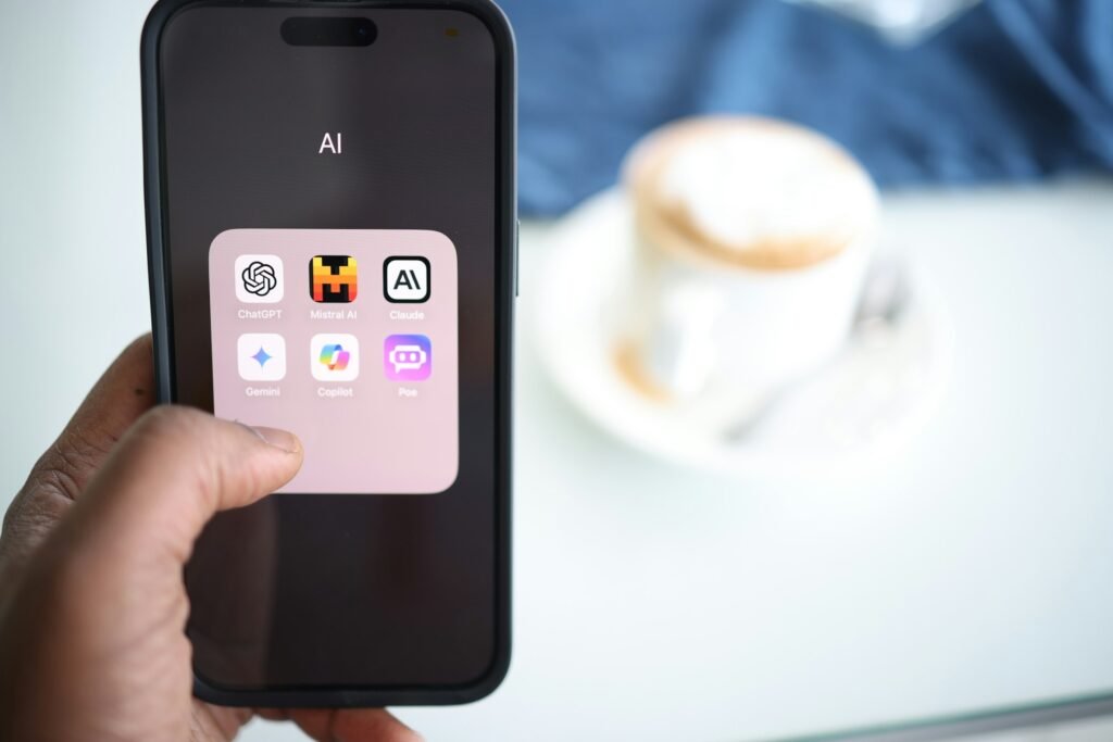 A person holding a smartphone with an AI assistant app open, like the Gemini app's new Chat and Task modes