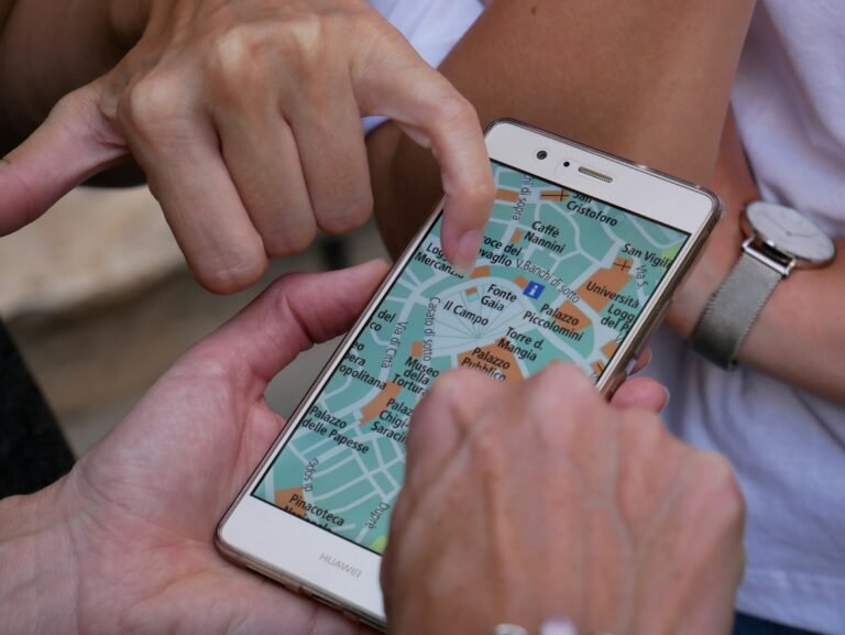 A person tapping a smartphone screen, the kind of location search Gemini's new Map tool is built for