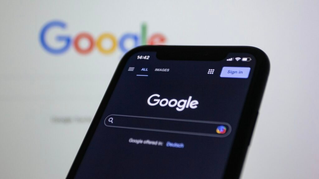 A smartphone held in front of the Google logo, as Google prepares to turn Gemini Gems into Skills on November 17