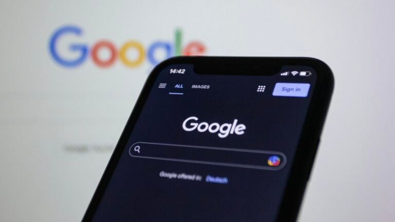 A smartphone held in front of the Google logo, as Google prepares to turn Gemini Gems into Skills on November 17
