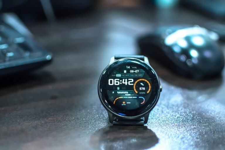 A smartwatch resting on an office desk, illustrating the monthly health trend reports now arriving on Pixel Watch