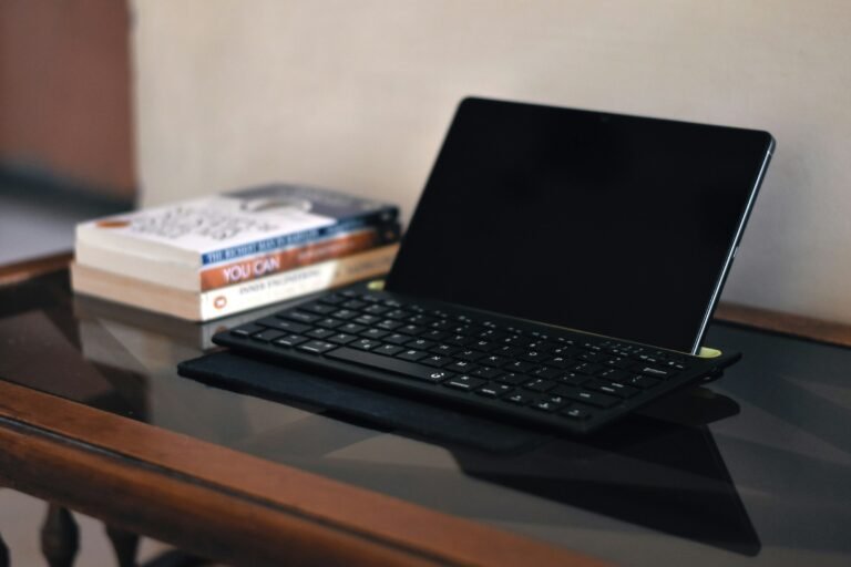 A tablet with a keyboard on a minimal desk with books, the kind of setup Amazon's new Alexa Tablet 12 Pro targets