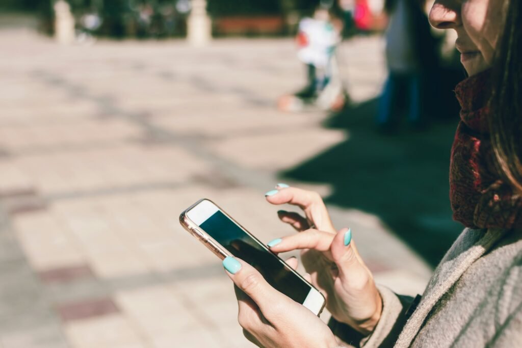 A woman looking at her smartphone, the kind of habit Google's Pause Point feature is designed to interrupt